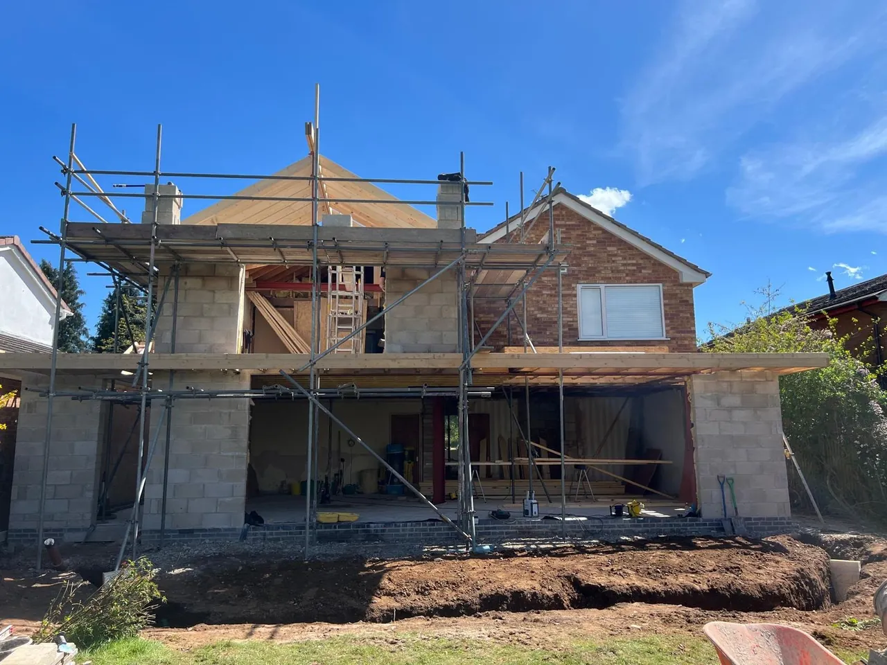 Two-storey extension in progress with scaffolding and roof structure