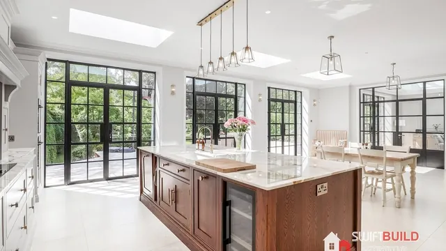 Refurbished open-plan kitchen with skylights and Crittall-style glazing