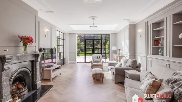 Refurbished period living room with fireplace and garden doors