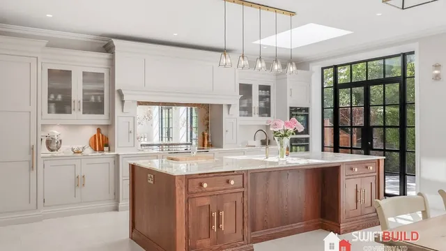 Kitchen refurbishment with wood island and black-framed garden doors