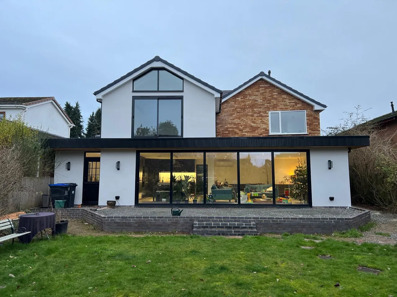 Modern two-storey rear extension with full-width glazing and rendered finish