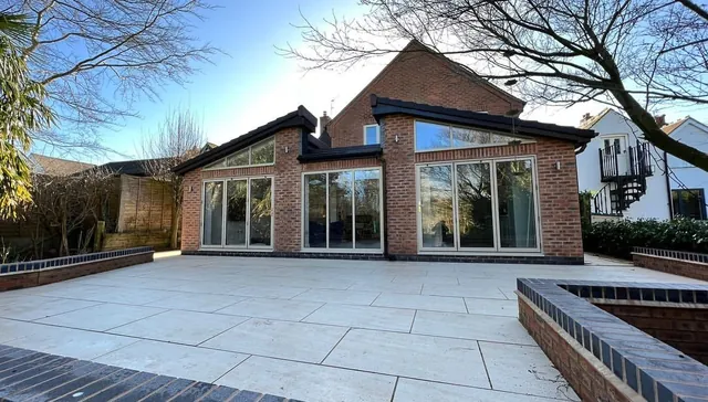 Single-storey rear extension with bi-fold doors and porcelain patio