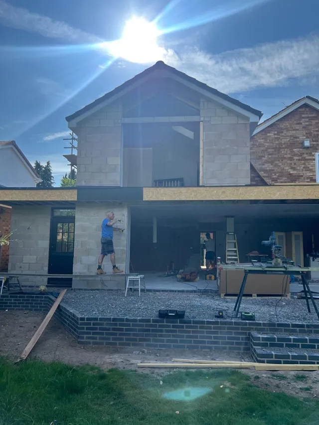 Two-storey extension under construction with blockwork shell