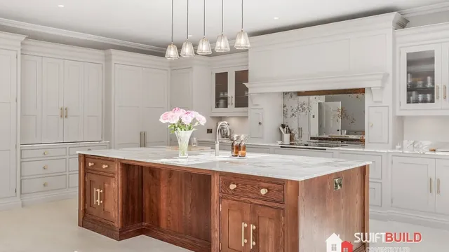 White shaker kitchen with walnut island after refurbishment