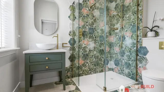 Bathroom refurbishment with green vanity and hexagon shower tiles